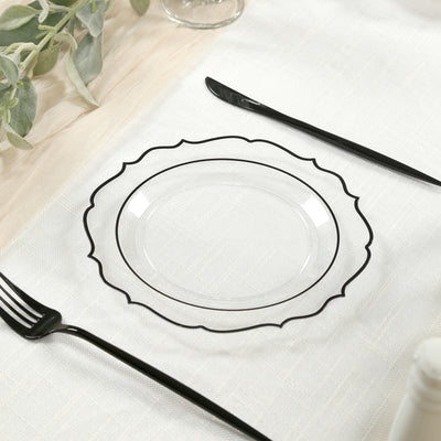 Clear decorative plate with black rim on a textured table setting.