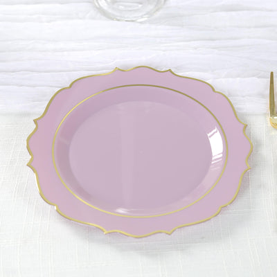 Pink decorative plate with gold rim detail on white background.