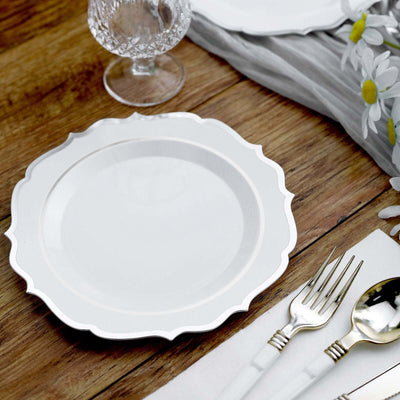 Elegant white scalloped dinner plate on a rustic wooden table