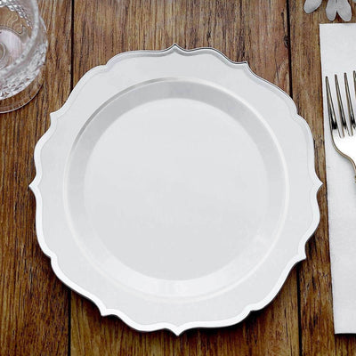 Elegant white plate with decorative edge on wooden table.