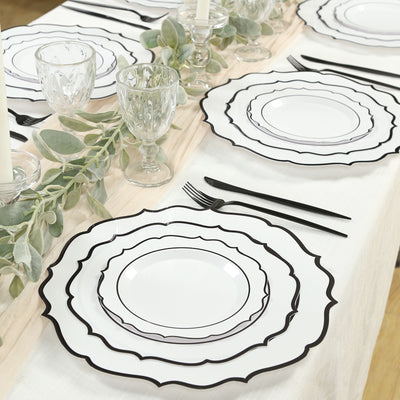 Elegant black and white dinner plates set on a beautifully arranged table.