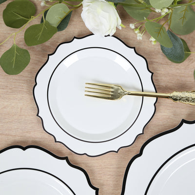Elegant white plate with black trim and gold fork on a wooden table.