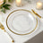 Elegant clear glass plate with gold rim, styled with cutlery and candles.