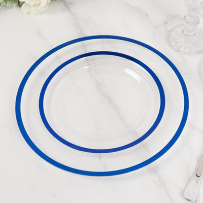 Clear plates with blue rims, stacked on a marble surface.
