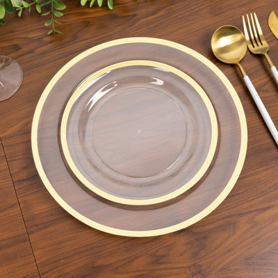 Elegant glass plate with gold rim on wooden table setting.