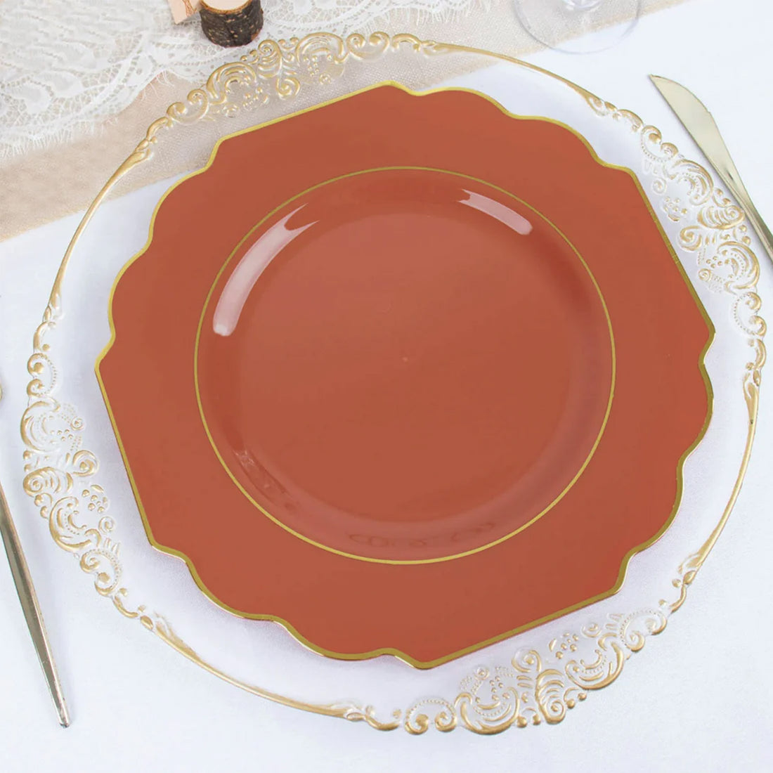 Elegant brown decorative plate with gold trim on a clear glass charger plate.