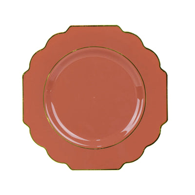 Coral decorative plate with gold trim and scalloped edges
