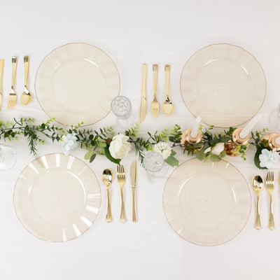 Elegant dinner table setting with plates, cutlery, and floral decor.
