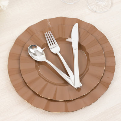 Brown dinnerware set with silver cutlery on layered plates.