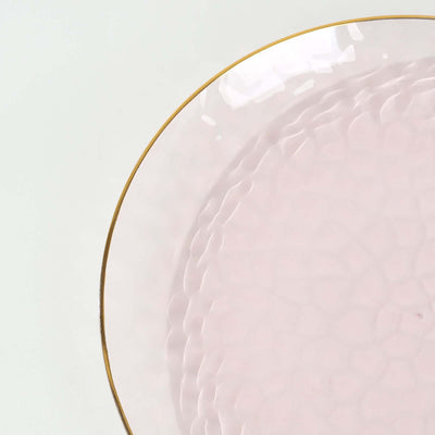 Elegant pink glass plate with a gold rim detail.