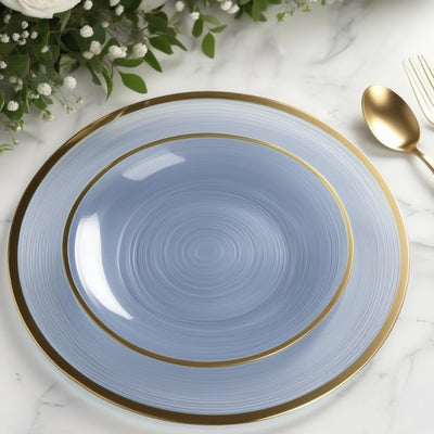 Elegant blue plate with gold rim on a marble surface.