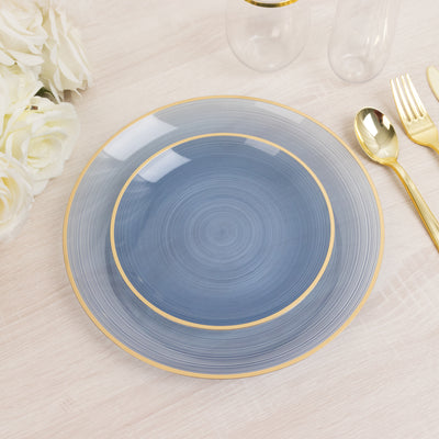 Blue decorative plate with gold rim on a light wooden surface.