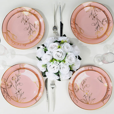 Set of four elegant pink floral dinner plates with gold accents.