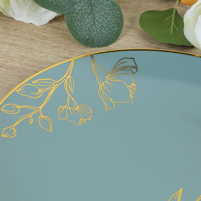 Decorative teal plate with gold floral design on a wooden surface.
