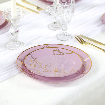Elegant purple plate with floral design and gold trim on a dining table.