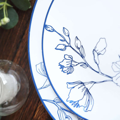 Floral-patterned dinner plates stacked on a wooden table.
