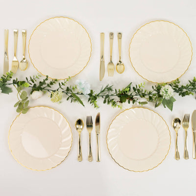 Elegant dinnerware set with gold accents arranged with greenery