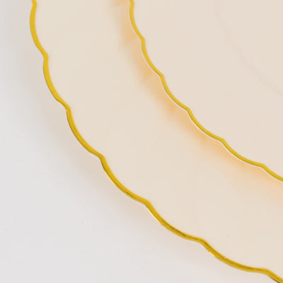 Elegant scalloped edge plates with gold trim.