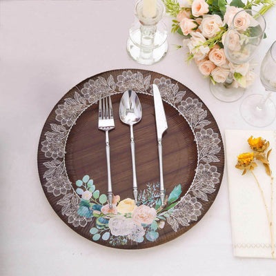 Elegant wooden plate with floral design, cutlery, and table setting.