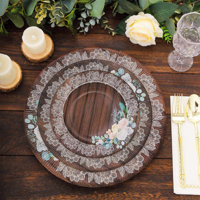 Decorative layered plates with floral lace design on a rustic wooden table.