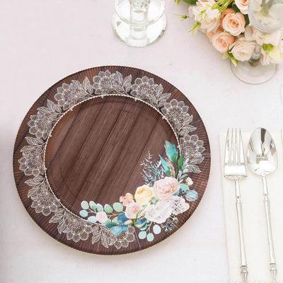 Decorative brown plate with floral design and lace border on a dining table setting.