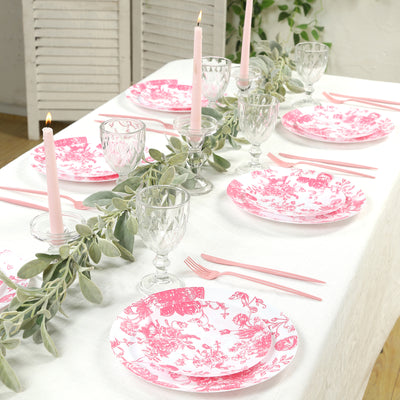 Elegant pink floral dinnerware set on a beautifully arranged dining table.