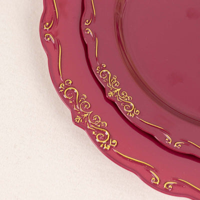 Elegant burgundy plates with gold ornate detailing.