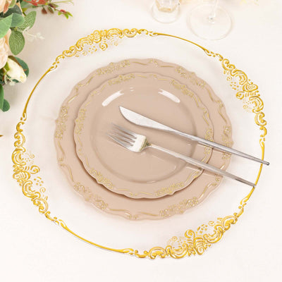 Elegant gold-trimmed plates with fork and knife on a table.
