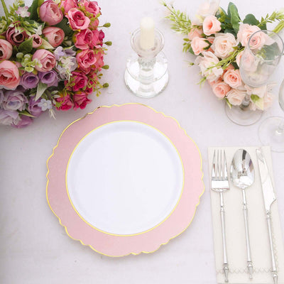 Elegant pink scalloped dinner plate with gold trim, styled with floral arrangements.