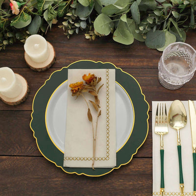 Elegant dinner setting with green plate, floral napkin, and gold-accented cutlery.