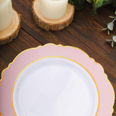 Elegant pink and gold rimmed dinner plate on rustic wooden table.