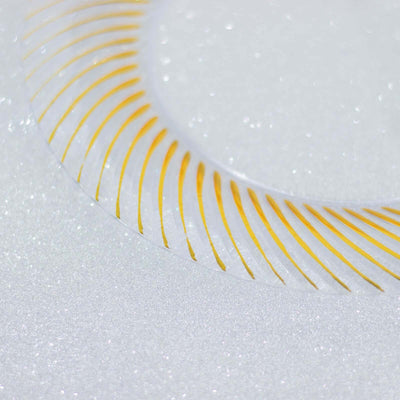 Gold decorative plate with elegant pattern on a sparkling background.