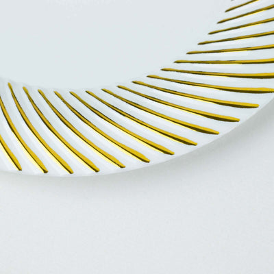 Elegant white plate with gold striped design.