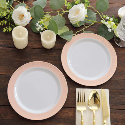 Elegant dining setup with decorative plates, gold utensils, and floral accents.