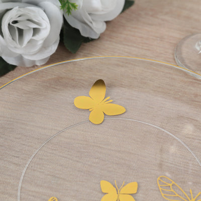 Gold butterfly design on transparent plate with floral background.