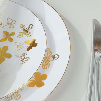 Elegant white plates with gold butterfly designs, stacked for a sophisticated table setting.