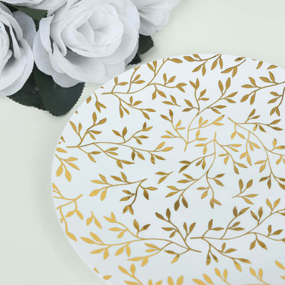 Elegant white plate with gold leaf design and decorative flowers.