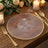 Elegant clear plate with geometric pattern and gold rim, set on a wooden table.