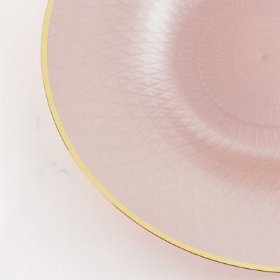 Pink decorative plate with geometric pattern and gold rim.