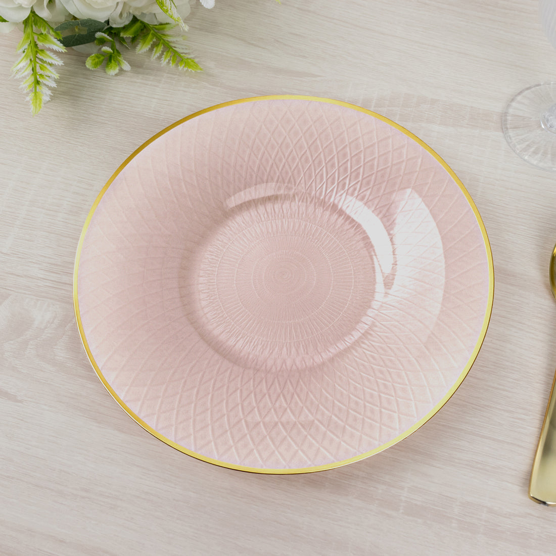 Pink decorative plate with golden rim and textured design.