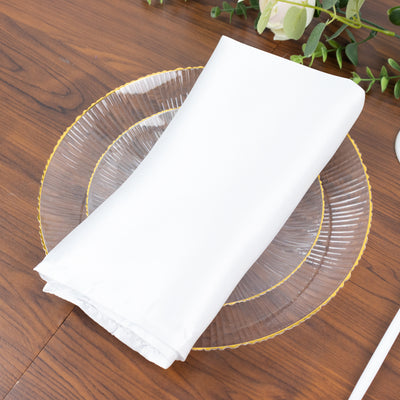 White napkin elegantly placed on a clear decorative plate.
