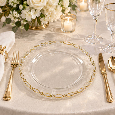 Elegant gold and glass wedding table setting with floral centerpiece and candles