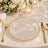 Elegant gold and glass wedding table setting with floral centerpiece and candles