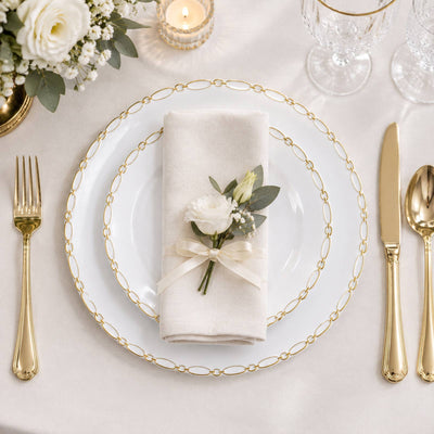 Elegant wedding table setting with gold flatware and floral napkin decor