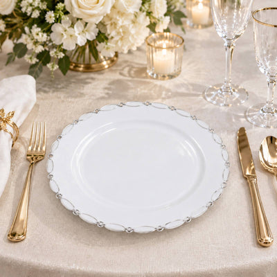 Elegant gold flatware place setting with white plate and floral centerpiece