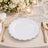 Elegant gold flatware place setting with white plate and floral centerpiece