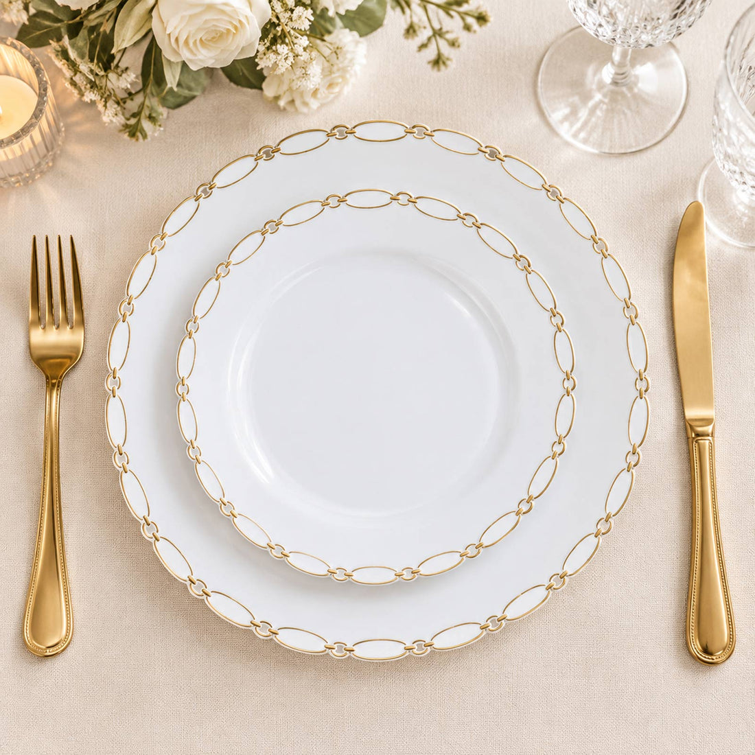 Elegant gold-rimmed white dinnerware place setting with floral decor