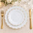 Elegant gold-rimmed white dinnerware place setting with floral decor