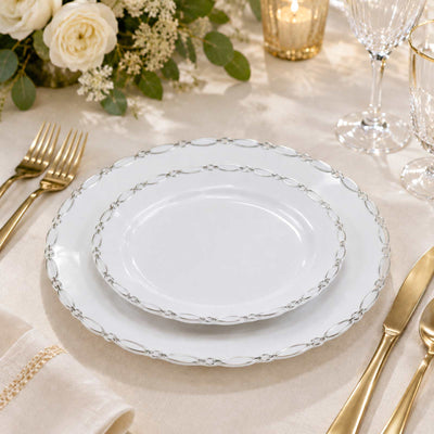 Elegant white charger plates with silver chain trim on a gold table setting