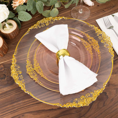 Elegant golden rimmed plate with white napkin and holder on a wooden table.